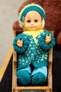 Portrait of cute baby girl sitting on toy