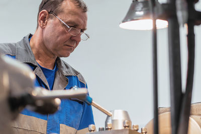 Side view of man working at workshop