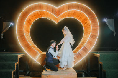 Bridegroom against glowing heart shape