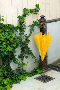 High angle view of yellow umbrella hanging on bollard