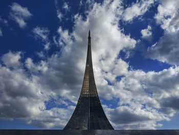 Low angle view of building against cloudy sky