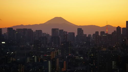 High angle view of illuminated cityscape against sky at night