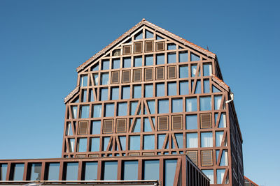 Low angle view of building against clear blue sky