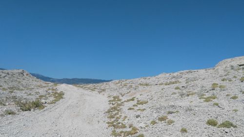 Scenic view of mountains against clear blue sky