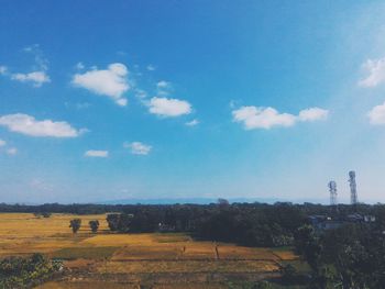 Scenic view of field against blue sky