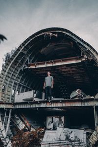 Low angle view of man standing against sky