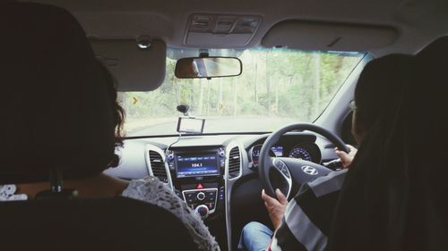 Rear view of people traveling in car