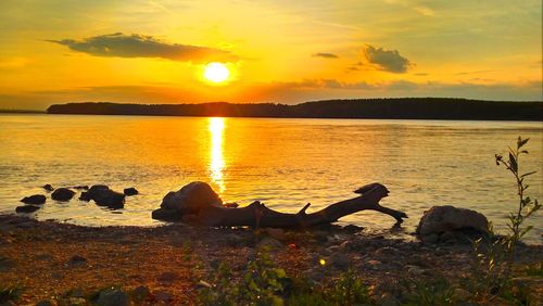 Scenic view of sunset over lake