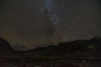 Scenic view of mountains against sky at night