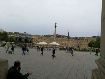 People at town square against sky