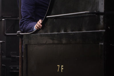 Midsection of man standing in factory
