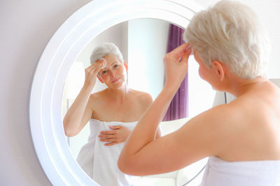 Side view of young woman in bathroom