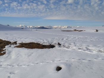 Scenic view of snowcapped mountains against sky