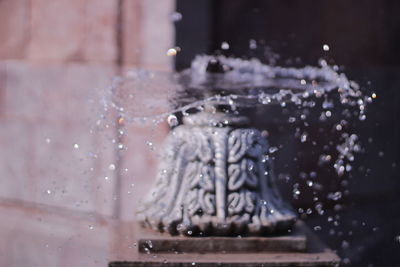 Close-up of water splashing on glass