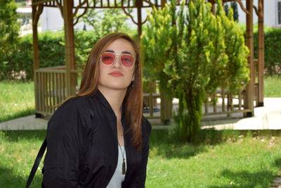 Portrait of beautiful young woman in park