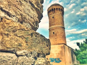 Low angle view of old tower against sky
