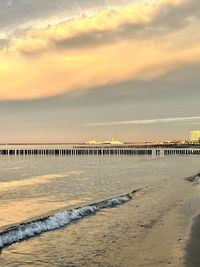 Scenic view of beach against sky during sunset