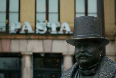 Statue against old building