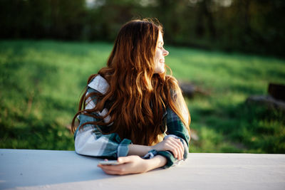 Rear view of woman using mobile phone