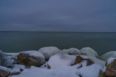 Frozen sea against sky