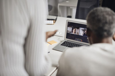 Midsection of woman using laptop