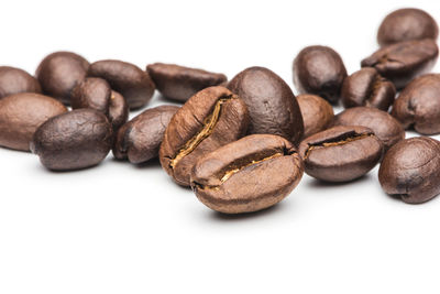 Close-up of coffee beans against white background