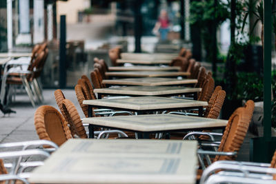 Chairs and tables arranged at outdoor restaurant