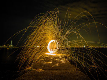 Wire wool against sky at night