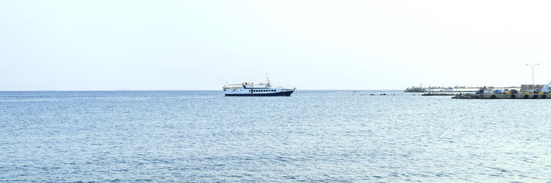 Sailboat sailing on sea against clear sky