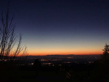 Silhouette cityscape against sky during sunset