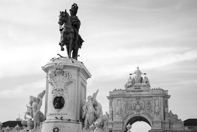 Low angle view of statue against cloudy sky