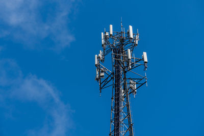 Low angle view of communications tower against sky