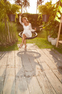 Full length portrait of woman in yard