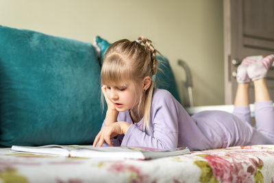 Girl reading book at home