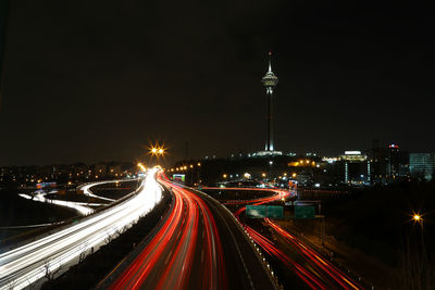 Light trails on road in city at night