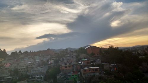 View of town against cloudy sky