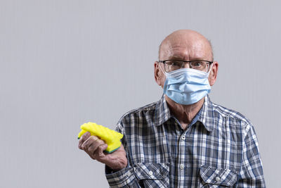 Portrait of man wearing mask against white background