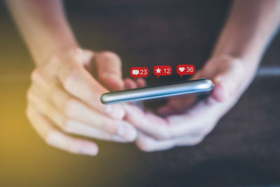 Close-up of hand holding mobile phone