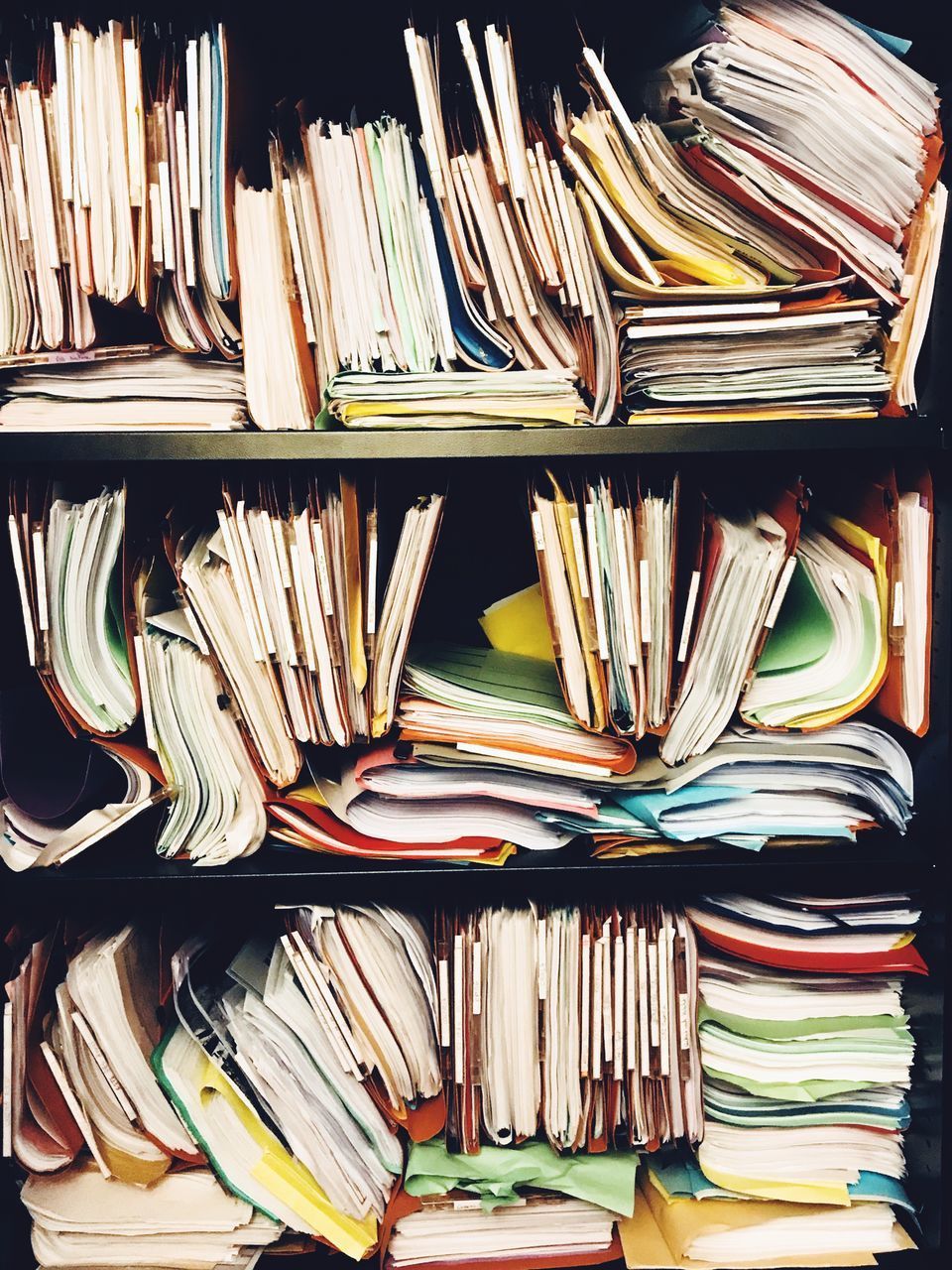 STACK OF BOOKS IN SHELF