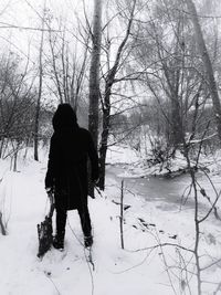 Rear view of man on snow covered field