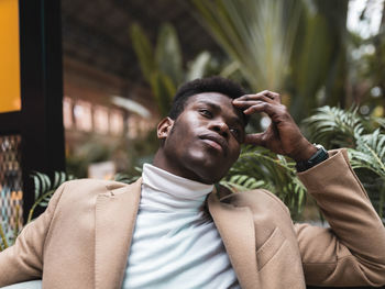 Portrait of young man looking away outdoors