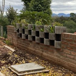 Built structure by trees on field against sky