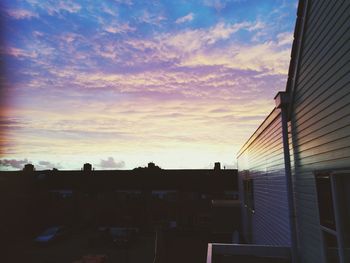 Silhouette of building against sunset sky