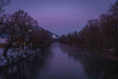 Scenic view of lake against sky during winter