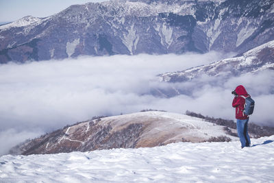 Woman standing on snow covered mountain