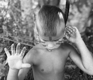 Look at my war paint. feather behind my ear. woods. black and white. creative. nature. trees 