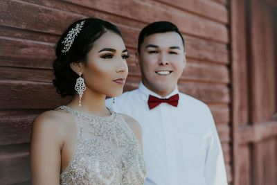 Portrait of young couple standing outdoors