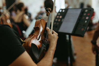 Midsection of man playing guitar