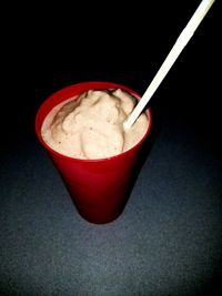 Close-up of ice cream on table against black background