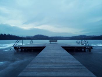 Pier over lake against sky